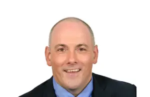 The Rt Hon Rob Halfon | Apprenticeship and Training Awards | Apprenticeship and Training Awards Professional headshot of a bald man in a dark suit and blue shirt, smiling at the camera.