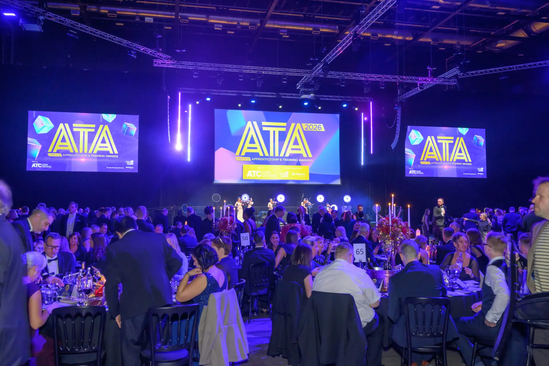 Guests seated at the Apprenticeship and Training Awards 2026 Gala Dinner, with the ATA stage screens behind.